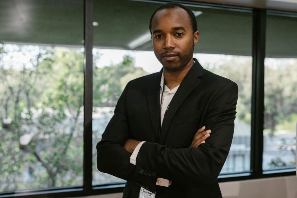Portrait of a confident man in corporate attire inside a modern office.